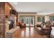 Bright living room with brick fireplace, built-in shelving and views to the back yard at 13758 Foxdale Lake Dr, Carmel, IN 46032