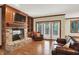 Cozy living room featuring a brick fireplace, built-in shelves, and sliding glass doors at 13758 Foxdale Lake Dr, Carmel, IN 46032