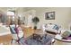 Elegant living room with comfortable seating and a grand staircase for seamless flow and sophisticated charm at 13758 Foxdale Lake Dr, Carmel, IN 46032