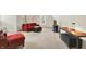An interior living space enhanced by a red couch and an ottoman, showcasing a comfortable sitting area at 13758 Foxdale Lake Dr, Carmel, IN 46032
