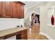 Home office featuring custom built-in cabinetry and desk, with views of living area at 13758 Foxdale Lake Dr, Carmel, IN 46032