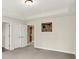 A room with neutral paint, an art piece, and view to white double doors at 13758 Foxdale Lake Dr, Carmel, IN 46032