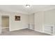 A spacious room with neutral paint, built-in shelving, and white trim and baseboards at 13758 Foxdale Lake Dr, Carmel, IN 46032