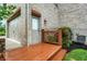 Wood-stained landing at door and garage entry; brick exterior detail with manicured garden bed at 13758 Foxdale Lake Dr, Carmel, IN 46032