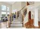 Elegant staircase with carpet and detailed ironwork, leading to upper levels of the home at 13758 Foxdale Lake Dr, Carmel, IN 46032