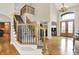 Stunning staircase with detailed ironwork and wooden banister in the foyer of the residence at 13758 Foxdale Lake Dr, Carmel, IN 46032