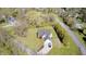 Aerial view of a charming home featuring a long driveway, two car garage, and a well manicured lawn at 138 Fairway Dr, Indianapolis, IN 46260