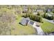 Aerial view of charming home with manicured lawn, long driveway and two-car garage, surrounded by lush greenery at 138 Fairway Dr, Indianapolis, IN 46260