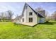Spacious backyard with lush green grass, a cozy patio, a swing set, and charming white brick accents at 138 Fairway Dr, Indianapolis, IN 46260