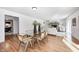 Elegant dining room with a glass-top table, modern chairs, and an open view into the cozy living space at 138 Fairway Dr, Indianapolis, IN 46260