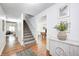 Welcoming entryway with hardwood floors, a staircase, and decorative touches, leading into the living space at 138 Fairway Dr, Indianapolis, IN 46260