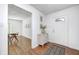 Inviting entryway featuring hardwood floors, modern decor, and a glimpse into the bright dining area at 138 Fairway Dr, Indianapolis, IN 46260