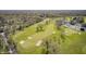 Aerial view of a lush green golf course, with sand traps, mature trees and manicured fairways at 138 Fairway Dr, Indianapolis, IN 46260