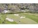 Aerial view of a lush golf course, featuring sand traps, mature trees and manicured fairways near residences at 138 Fairway Dr, Indianapolis, IN 46260