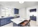 Kitchen showcases blue cabinets, a breakfast bar, stainless appliances and a large window at 138 Fairway Dr, Indianapolis, IN 46260