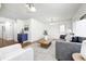 Inviting living room with a gray sofa, plush chairs, and stylish accents creating a comfortable living space at 138 Fairway Dr, Indianapolis, IN 46260