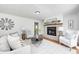 Cozy living room with a brick fireplace, plush seating, and stylish decor, perfect for relaxing at 138 Fairway Dr, Indianapolis, IN 46260