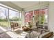 Sunroom with ample seating, natural light, and views of the landscaped yard at 138 Fairway Dr, Indianapolis, IN 46260