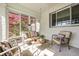 Sunroom with ample seating, natural light, and views of the landscaped yard at 138 Fairway Dr, Indianapolis, IN 46260
