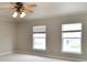 Spacious bedroom with neutral walls and a ceiling fan with windows at 13858 Meadow Lake Dr, Fishers, IN 46038