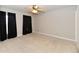 Bright bedroom featuring dark curtains, neutral carpet and ceiling fan at 13858 Meadow Lake Dr, Fishers, IN 46038