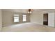 Spacious carpeted bedroom with neutral walls, fan, and two windows at 13858 Meadow Lake Dr, Fishers, IN 46038