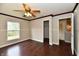 Bright bedroom featuring hardwood flooring, ceiling fan and connected walk-in closet at 13858 Meadow Lake Dr, Fishers, IN 46038