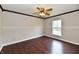 Cozy bedroom with hardwood flooring, ceiling fan, and bright window at 13858 Meadow Lake Dr, Fishers, IN 46038