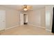 Bright bedroom featuring neutral carpet and ceiling fan with connected walk-in closet at 13858 Meadow Lake Dr, Fishers, IN 46038