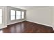 A light filled room, with dark wood floors and a door to the left at 13858 Meadow Lake Dr, Fishers, IN 46038