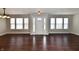 Bright entryway featuring beautiful dark wood floors, a white front door, and natural light at 13858 Meadow Lake Dr, Fishers, IN 46038