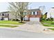 A traditional brick two-story house with a concrete driveway and a well-maintained lawn at 13858 Meadow Lake Dr, Fishers, IN 46038