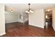 Open concept living room with hardwood floors and views into the kitchen at 13858 Meadow Lake Dr, Fishers, IN 46038