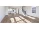 Hardwood floors extend through the living room to the kitchen, offering an open floor plan with plenty of light at 14533 Hanford Ln, Carmel, IN 46074