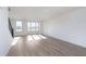 Sunlit living room showcasing hardwood floors, large windows, and neutral paint palette at 14551 Hanford Ln, Carmel, IN 46074