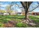 Lush backyard featuring mature trees, providing a serene and private outdoor space for relaxation at 1457 Biloxi Ln, Beech Grove, IN 46107