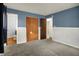 Cozy bedroom featuring carpeted floors, neutral paint, and ample closet space for storage at 1457 Biloxi Ln, Beech Grove, IN 46107