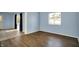 Open living area featuring modern flooring, neutral paint, and lots of natural light at 1457 Biloxi Ln, Beech Grove, IN 46107