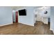 Open-concept living space with sleek flooring seamlessly connects to the kitchen and dining area at 1457 Biloxi Ln, Beech Grove, IN 46107