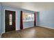 Inviting living room features a large window, modern flooring, and a stylish front door at 1457 Biloxi Ln, Beech Grove, IN 46107