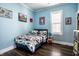 Cozy bedroom with blue walls, wood floors, and natural light at 1626 S Delaware St, Indianapolis, IN 46225