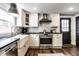 Modern kitchen with white cabinetry, stainless steel appliances, and stylish countertops and eat in area at 1626 S Delaware St, Indianapolis, IN 46225
