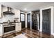 Kitchen featuring modern stainless steel appliances, white cabinetry, and access to a back entrance at 1626 S Delaware St, Indianapolis, IN 46225