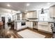 Bright, open kitchen with stainless steel appliances and white cabinets and eat in area with stylish pendant lights at 1626 S Delaware St, Indianapolis, IN 46225