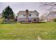 Spacious backyard with large deck, mature trees, and lush green lawn at 16994 Folly Brook Rd, Noblesville, IN 46060