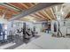 Unfinished basement area set up as a home gym with workout equipment and exposed ceiling at 16994 Folly Brook Rd, Noblesville, IN 46060