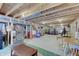 Partially finished basement with exposed beams, workout area, and potential living space at 16994 Folly Brook Rd, Noblesville, IN 46060