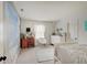 Bright bedroom with beach-themed wallpaper, desk, and comfortable chair at 16994 Folly Brook Rd, Noblesville, IN 46060