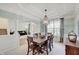 Well-lit dining room with open access to the living area, showcasing elegant decor and a large window at 16994 Folly Brook Rd, Noblesville, IN 46060