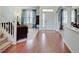 Elegant foyer with hardwood floors, staircase, and views into the living room, and dining room at 16994 Folly Brook Rd, Noblesville, IN 46060
